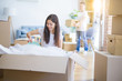 © Krakenimages.com - Young beautiful couple open cardboard boxes to order new home