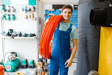 Sticker - Plumber holds pipe roll in plumbering store