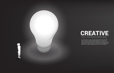 Poster - Silhouette of businesswoman standing with light bulb . Business Concept of creative idea and solution.