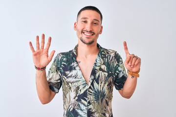 Wall Mural - Young handsome man wearing Hawaiian summer shirt over isolated background showing and pointing up with fingers number six while smiling confident and happy.