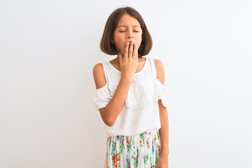 Sticker - Young beautiful child girl wearing casual dress standing over isolated white background bored yawning tired covering mouth with hand. Restless and sleepiness.