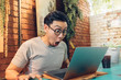 © Sevendeman - Shocked and surprised face of man works on his laptop in the cafe.
