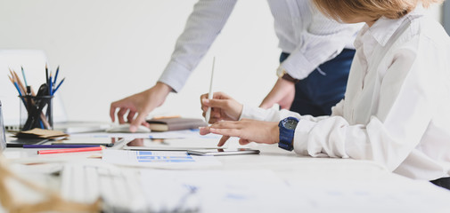 Cropped shot of young business people discussing on the project together