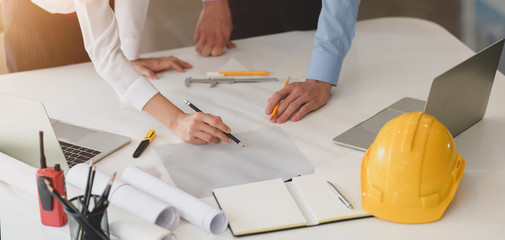 Wall Mural - Young architect and engineer working on their construction project together