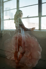 film double exposure of model standing in window with flowers