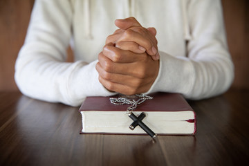 Wall Mural - A woman sitting and reading the bible And pray for God's blessing with faith in His power The idea of faith in the sacred power of God through prayer to Him Christianity, Jesus