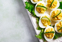 Deviled Eggs With Cucumber As An Appetizer, Top View, Copy Space