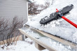 Gutters with ice dam and broom for raking snow off of roof