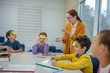 © zinkevych - Teacher helping school children playing words game