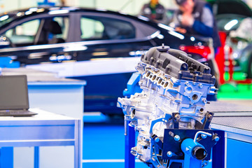 Poster - assembly of cars. engine on the background of a new car body. locksmith tests the mechanisms of the 