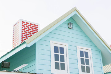 The roof of the blue house and red chimney