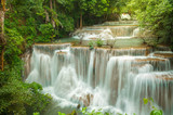 Fototapeta Most - Breathtaking waterfall at deep forest, Tropical rain forest or evergreen forest with waterfall, Erawan waterfall located Kanchanaburi Province, Thailand