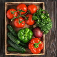 Fresh And Juicy Vegetables In A Wooden Box. Vegetable Salad Ingredients. Cucumbers, Tomatoes, Paprika, Onions, Herbs