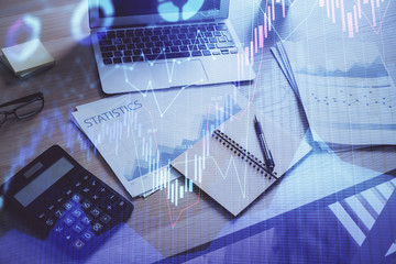 Financial graph colorful drawing and table with computer on background. Double exposure. Concept of international markets.