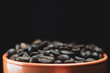 roasted coffee beans in a mug closeup