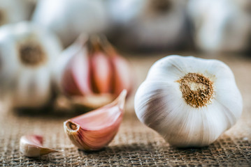 Wall Mural - Garlic clove and bulb in wooden basket vintage background.