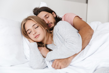 Sticker - Beautiful young couple laying in bed