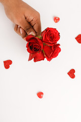 Wall Mural - Red rose in hands of young man