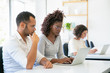 © Mangostar - Thoughtful African American workers working with laptop. Side view of focused young woman typing on laptop at office. Technology concept