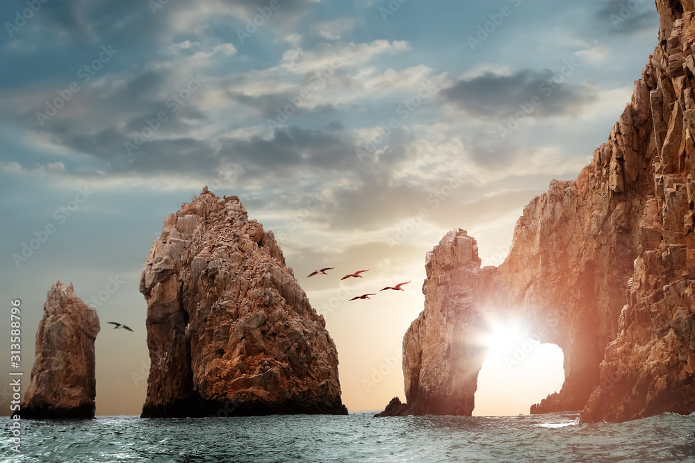 Rocky formations on a sunset background. Famous arches of Los Cabos. Mexico. Baja California Sur. - obrazy, fototapety, plakaty 