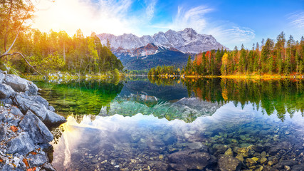 Wall Mural - faboulus autumn landscape of eibsee lake in front of zugspitze summit under sunlight