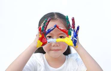 Wall Mural - Adorable little girl looking through her triangle colorful hands painted over white background.