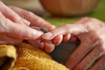 Wall Mural - Nail care service at salon, removing cuticle with nail nipper 