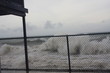 Water surge during hurricane Maria waves crashing on fence on beach