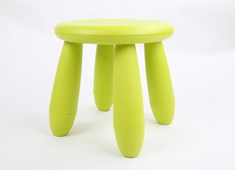 Small green plastic stool for kids isolated on white 