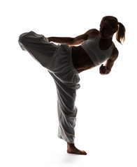 Wall Mural - Karate woman posing standing on one leg