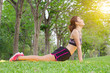 © NopponPAT - Young Asian woman pose practicing yoga in beautiful nature. Meditation in morning sunny day in green park. Sport ghalth care lifestyle concept.