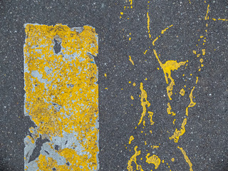 fluorescent yellow ground markings on a dark grey asphalt surface