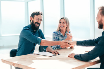 Wall Mural - smiling young man answering employers ' questions during the interview