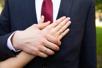 Bride and groom hands with wedding rings