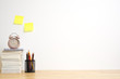 © Chalermpon - Office desk with pencils, alarm clock and book on wood table. work copy space.