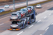 © aapsky - Transportation of new cars on a trailer with a truck for delivery to dealers.