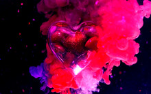 Beautiful Glass Heart With Small Red Shiny Hearts Inside On A Beautiful Pink And Blue Background.