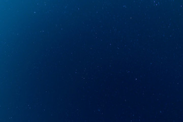 moving stars at night, dark blue sky background. long exposure shot.