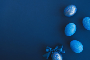 blue easter eggs painted by hand on a dark background. easter stylish minimal composition. top view,