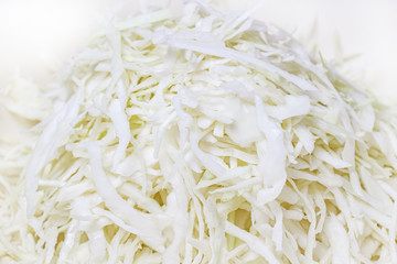 Fresh juicy chopped white cabbage in the metal bowl close-up