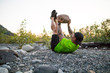 © Cavan Images - Fit man uses boulder in outdoor fitness routine
