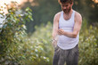 © Cavan Images - Man holding his hands together rubbing dirt and gravel for better grip