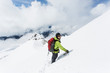 © Cavan Images - A young man descends from the summit of Mt. Hood on a cloudy day.