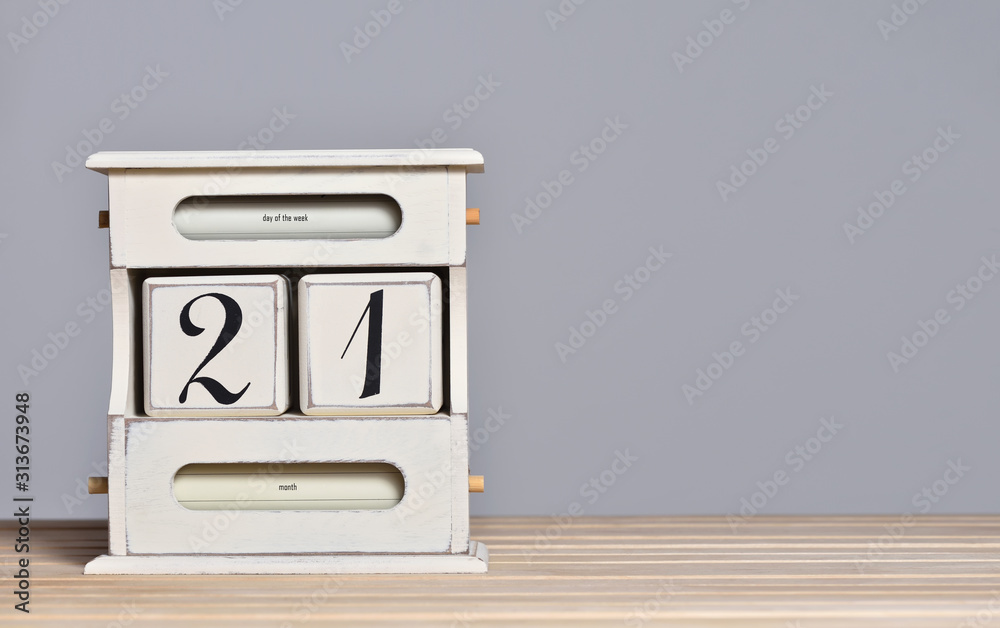 Desktop wooden retro calendar with day number 21. Calendar template for writing a holiday date and free text space
