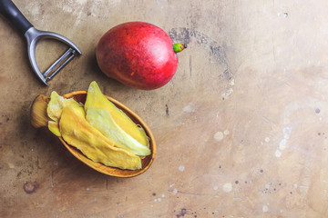 Wall Mural - Raw organic dried mango and fresh ripe mango fruit on rustic table. Healthy eating,raw food or diet concept. Top view. Flat lay