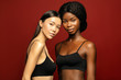 © Beauty Agent Studio - Multi Ethnic Group of beauty Womans with diffrent types of skin  together and looking on camera. Two Diverse ethnicity women -  African and Asian posing and smiling against red background.