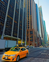 Wall Mural - Yellow taxi on road. Street view in Financial District of Lower Manhattan, New York of USA. Skyline and cityscape with skyscrapers at United States of America, NYC, US. American architecture.