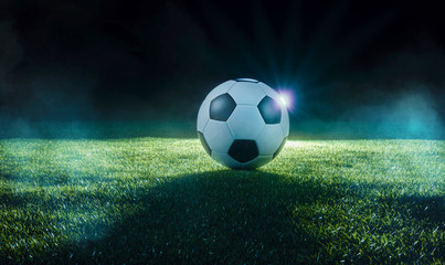 Football on an illuminated sports field at night