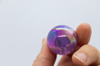 Hand Holding Opalized Amethyst Crystal Sphere