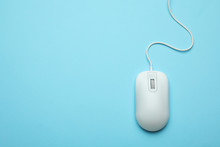 Wired Computer Mouse On Light Blue Background, Top View. Space For Text